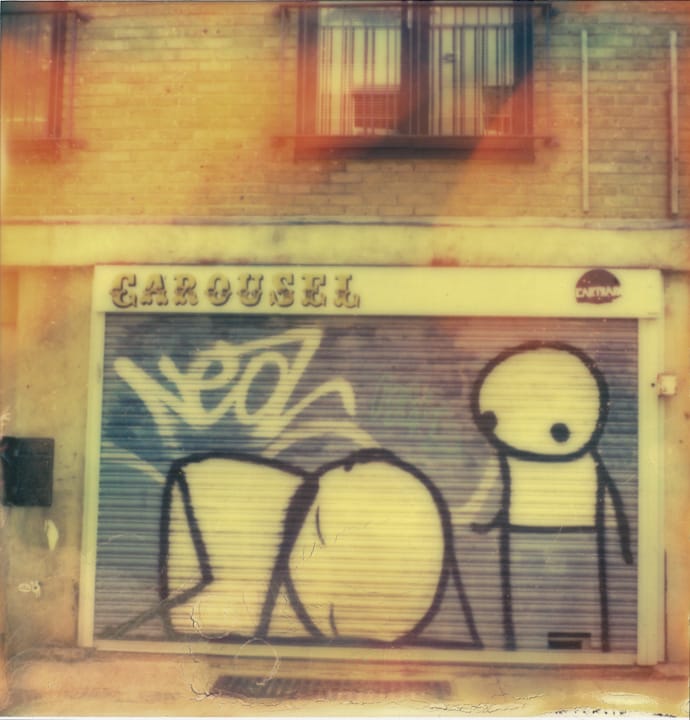 polaroid photograph of stickman street art on the carousel roller door. copyright leonie wise